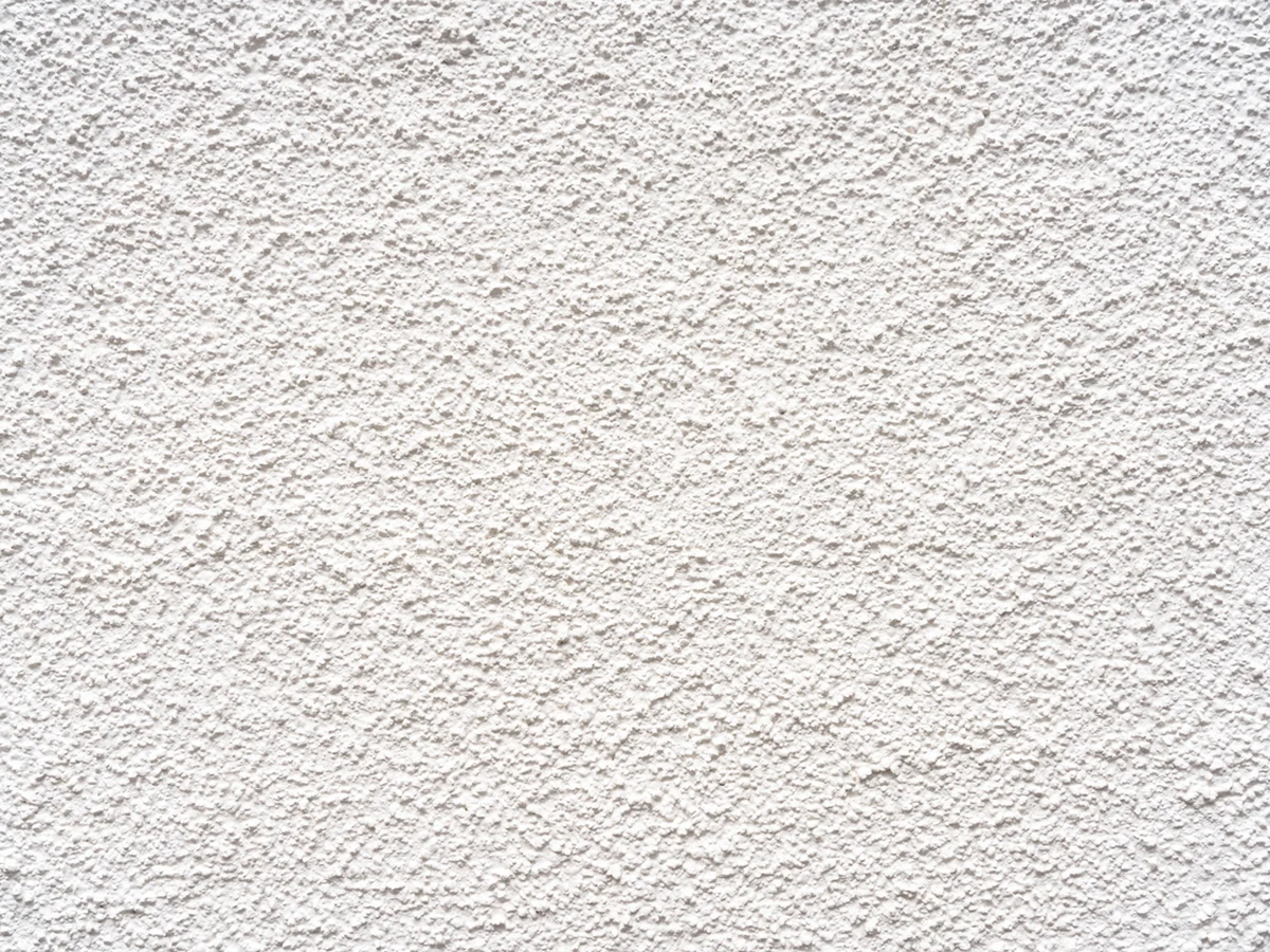 Exterior painting in Newton Poppleford, close-up of white textured render finish