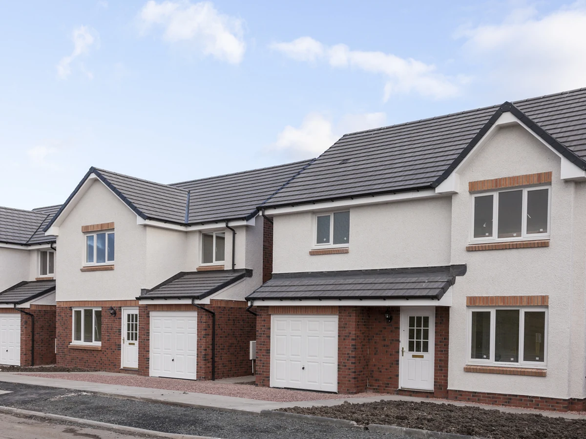 Row of white rendered properties with exterior painting in Seaton area by Exeter Decorators
