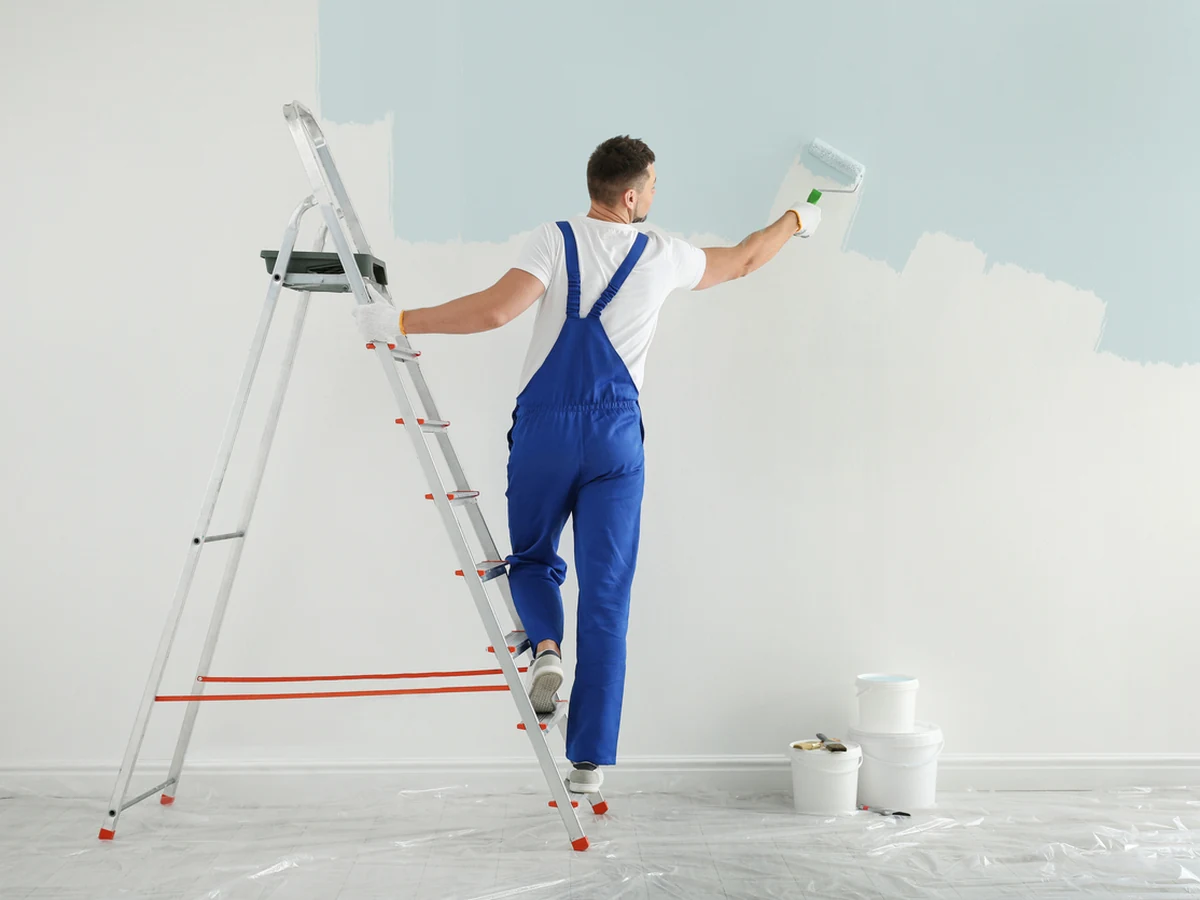 Painters and decorators in Seaton, Exeter Decorators painter in light blue ready for coastal property work