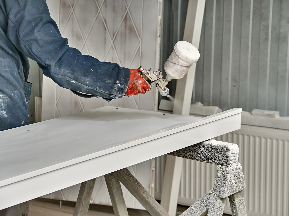painting-decorating-worker-spray-white-exeter-decorators Painters and decorators in Ottery St Mary, Exeter Decorators worker spray painting white