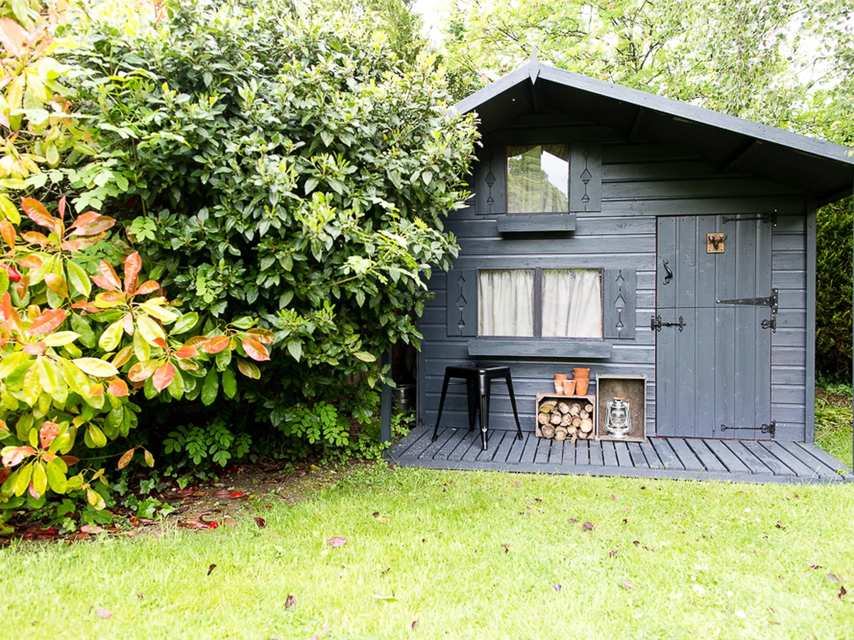 wood-painting-dark-wooden-garden-exeter-decorators Dark painted timber exterior — timber garage door painting by Exeter Decorators